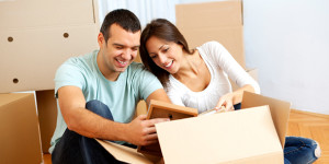 Couple Looking At Contents of Moving Box