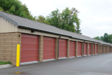 Secure outdoor storage units with red doors