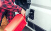 man refueling his camper van with a jerrycan