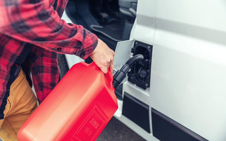 man refueling his camper van with a jerrycan