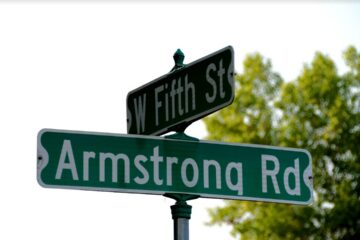 Street signs at the corner of West Fifth Street and Armstrong Road