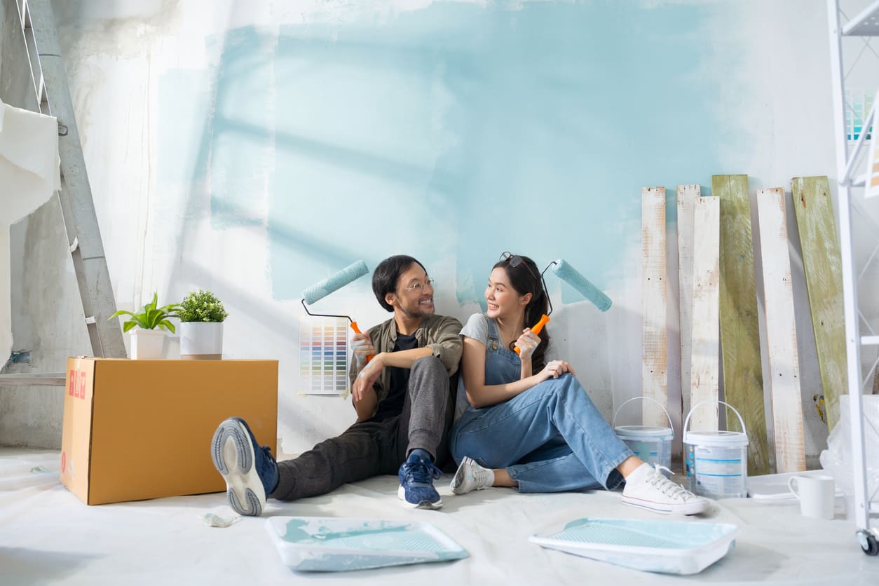 Couple painting a new house.