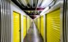A hallway of indoor self storage units that stretches far and long.