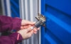 A first-time storage renter locks the door to her self storage unit.