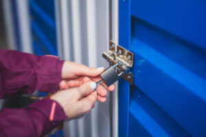 A first-time storage renter locks the door to her self storage unit.