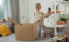 A college student packs boxes in her dorm as she moves.