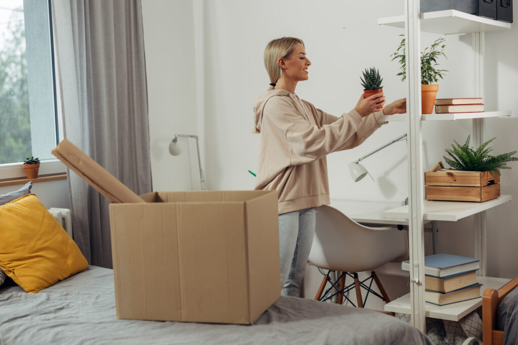 A college student packs boxes in her dorm as she moves.