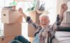 An older gentleman celebrates while packing his home during downsizing.