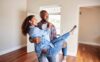 A happy newlywed couple walks into their new home together.