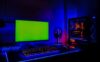 A gaming room with a PC, a widescreen monitor, and LED lighting.