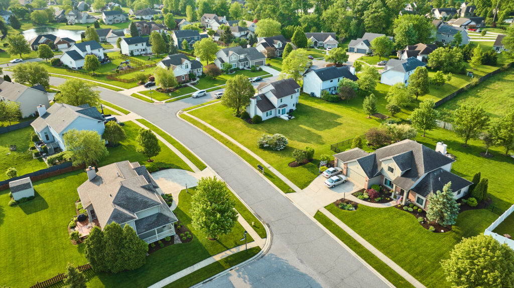 Aerial view of a quiet Minnesota suburb in autumn with red and gold trees, providing a calm setting for furniture storage.