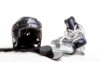 Assorted pieces of hockey equipment sitting an a floor.
