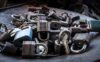 Four silver padlocks, both keyed and combination dial styles, stacked together for securing storage units.